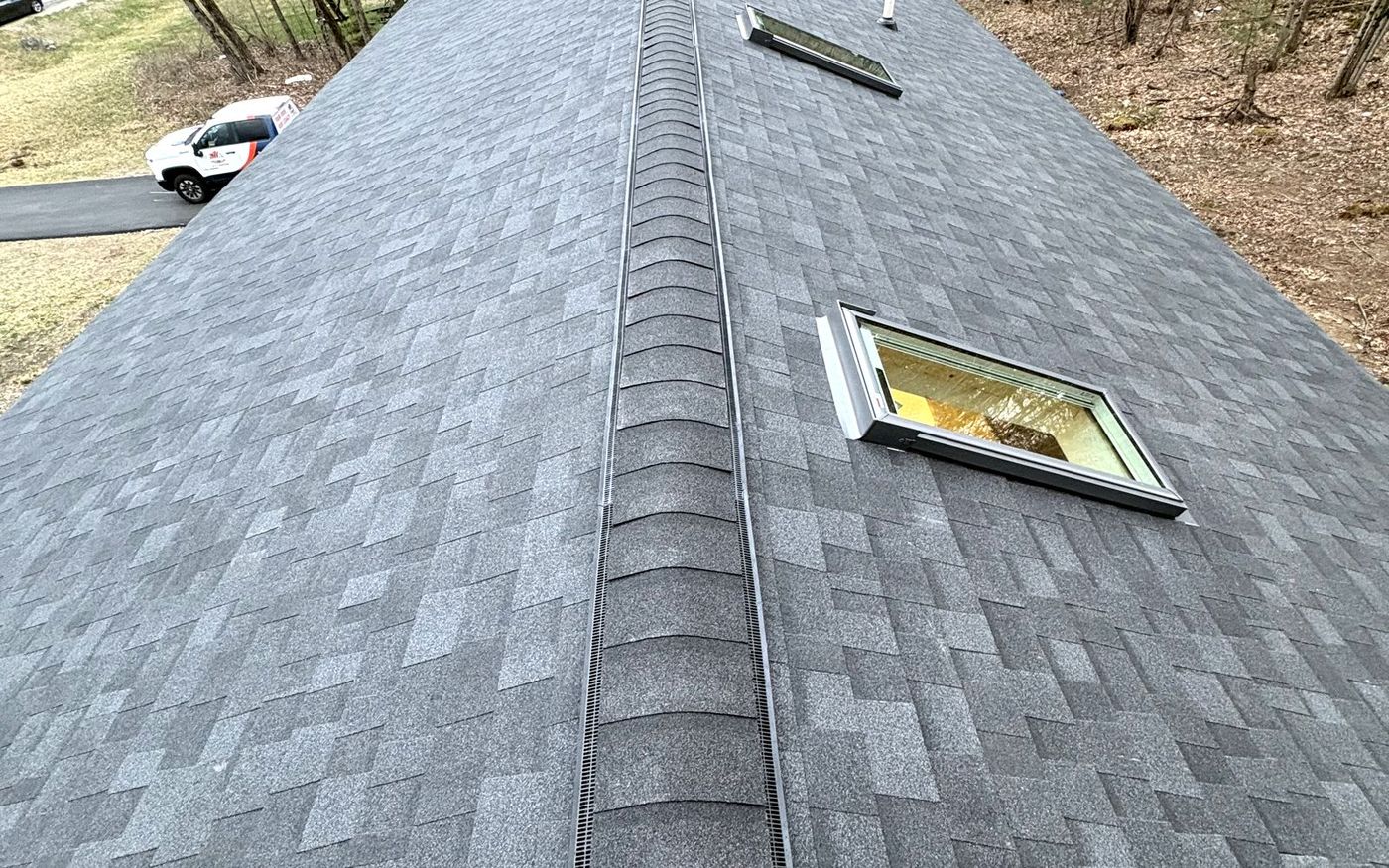 Completed roof replacement by A-Z Roofing with new architectural shingles and ridge vent