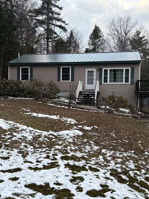 Storm-damaged roof section before repair