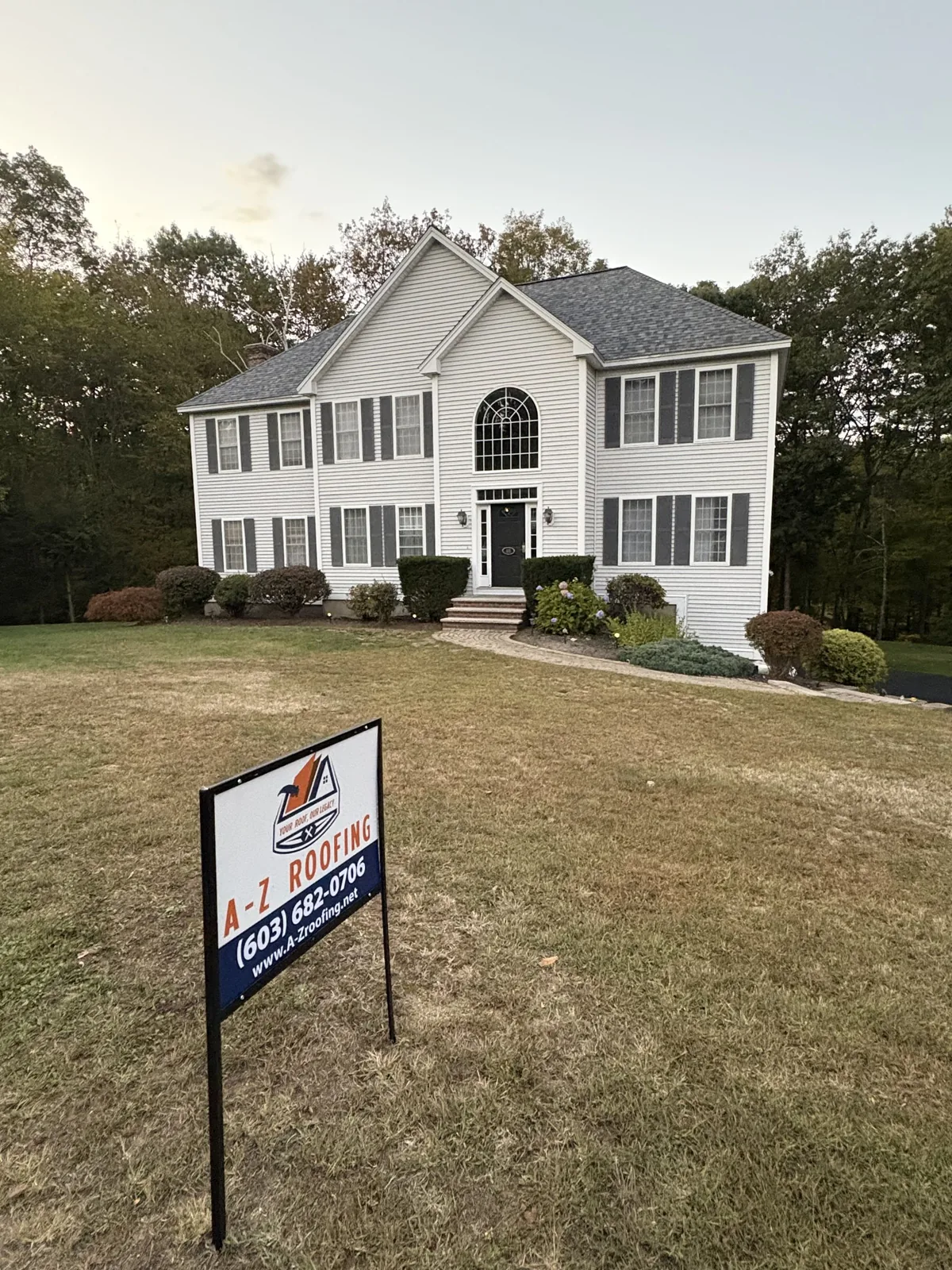 New roof installation nearing completion on a two-story home