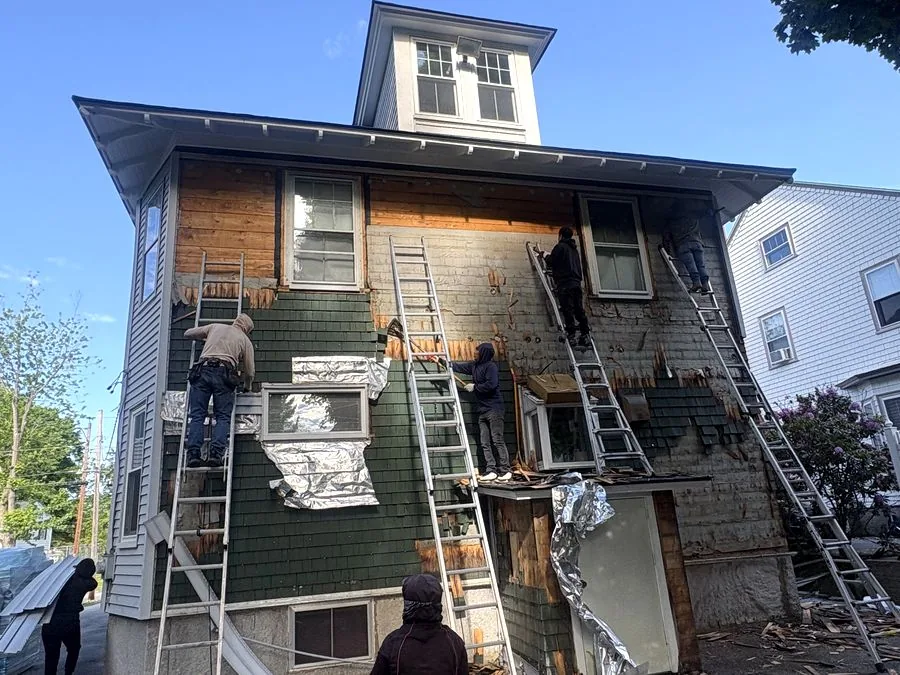 Gutter and siding work on a New England home